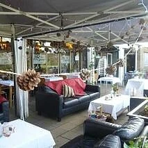 Outdoor café seating in an older visitor photo